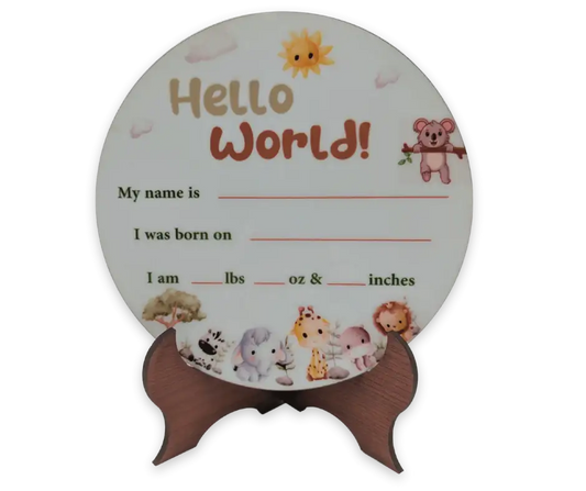 Round jungle animal birth announcement sign with "Hello World!" text and wooden stand