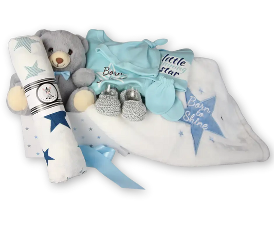 Blue baby gift box with teddy bear, muslin swaddle, knotted hat, mittens, booties, and blanket.