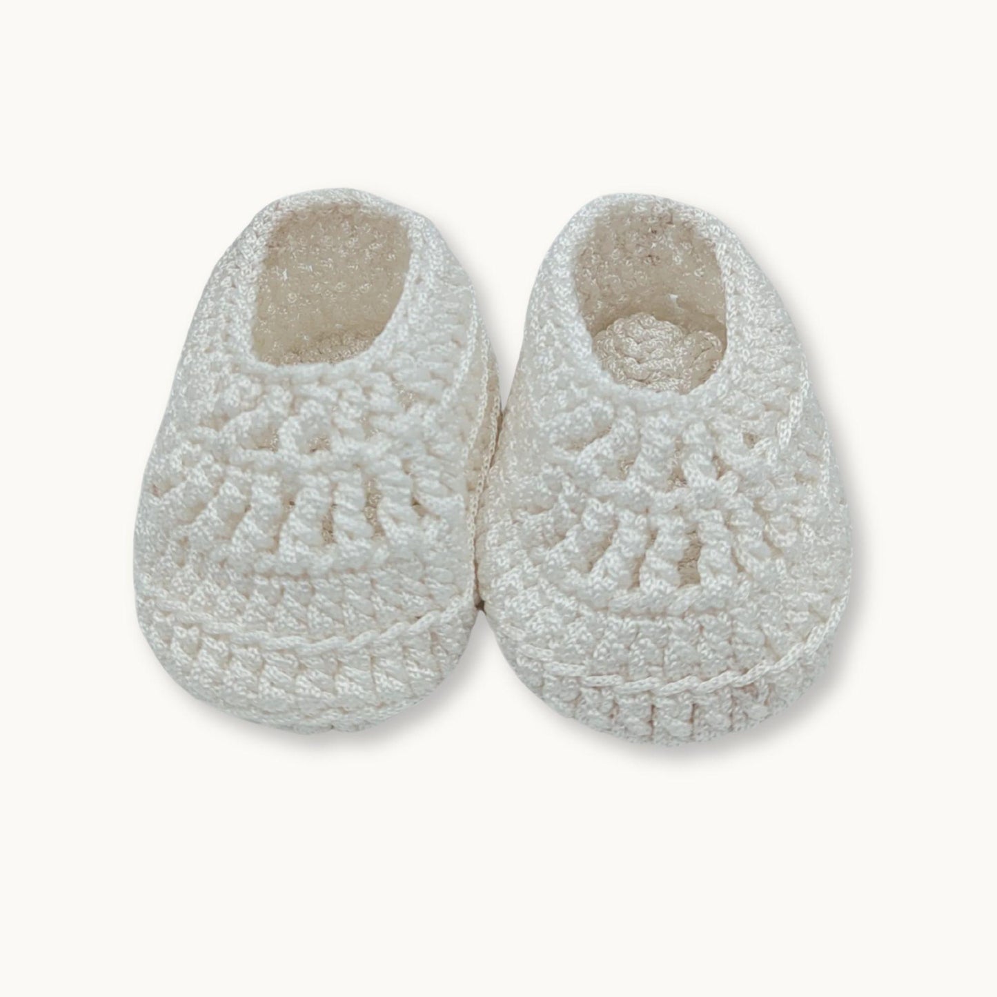 Pair of white fleece slippers on a white background