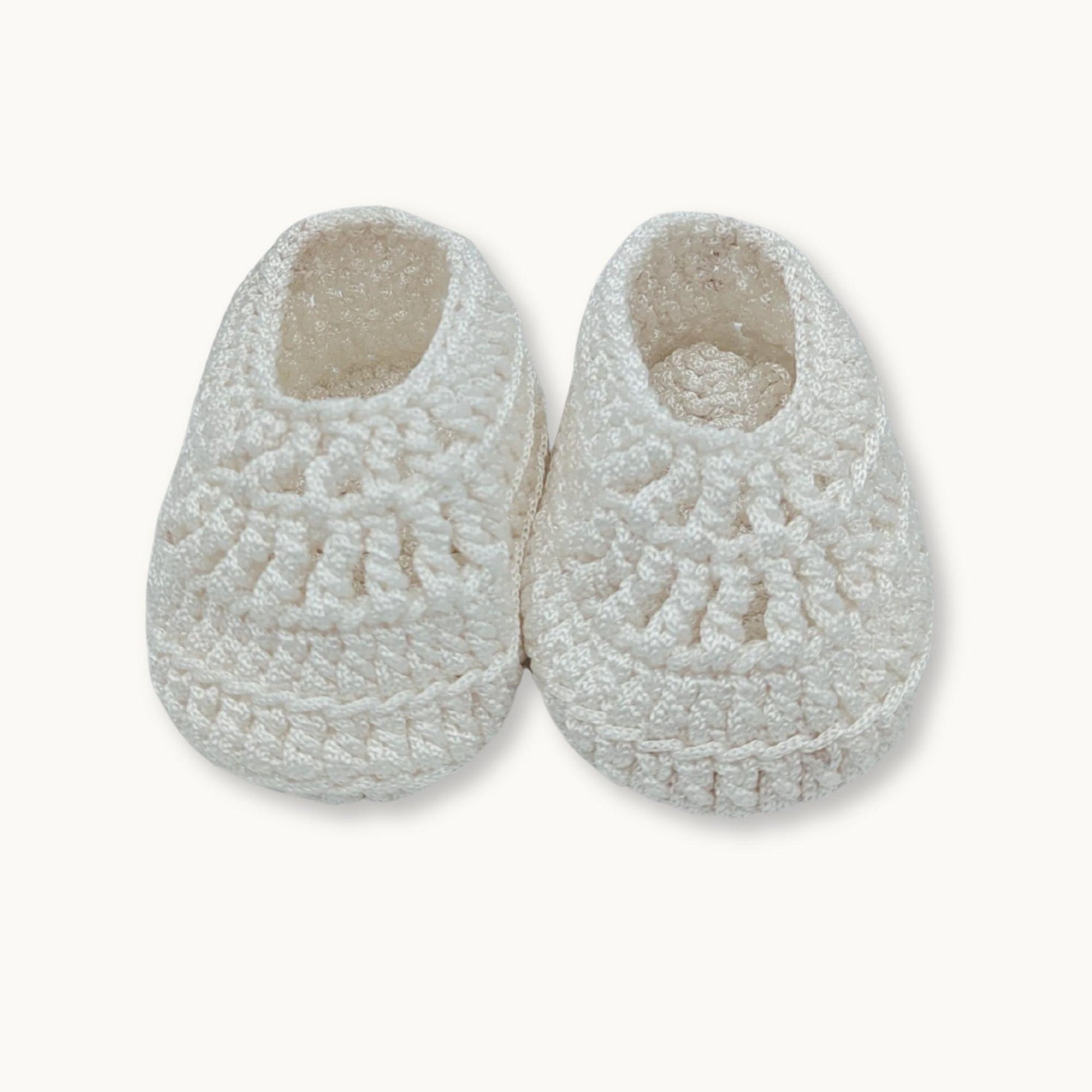 Pair of white fleece slippers on a white background
